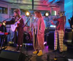 band playing on stage in pyjamas